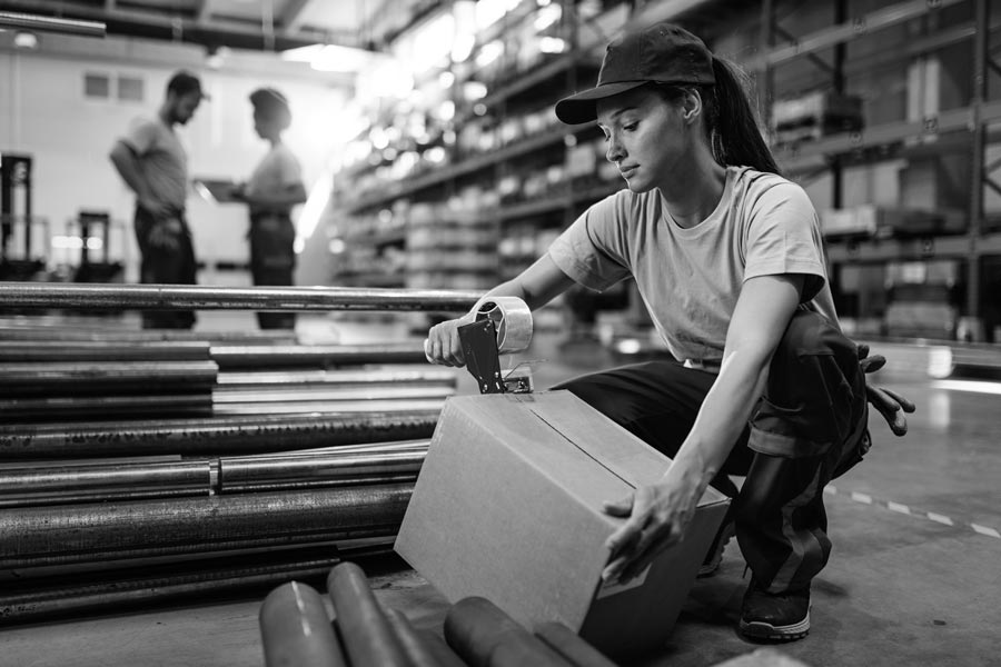 female-warehouse-worker-taping-cardboard-box-with-tape-dispenser-before-shiSSSSSpment-(2)
